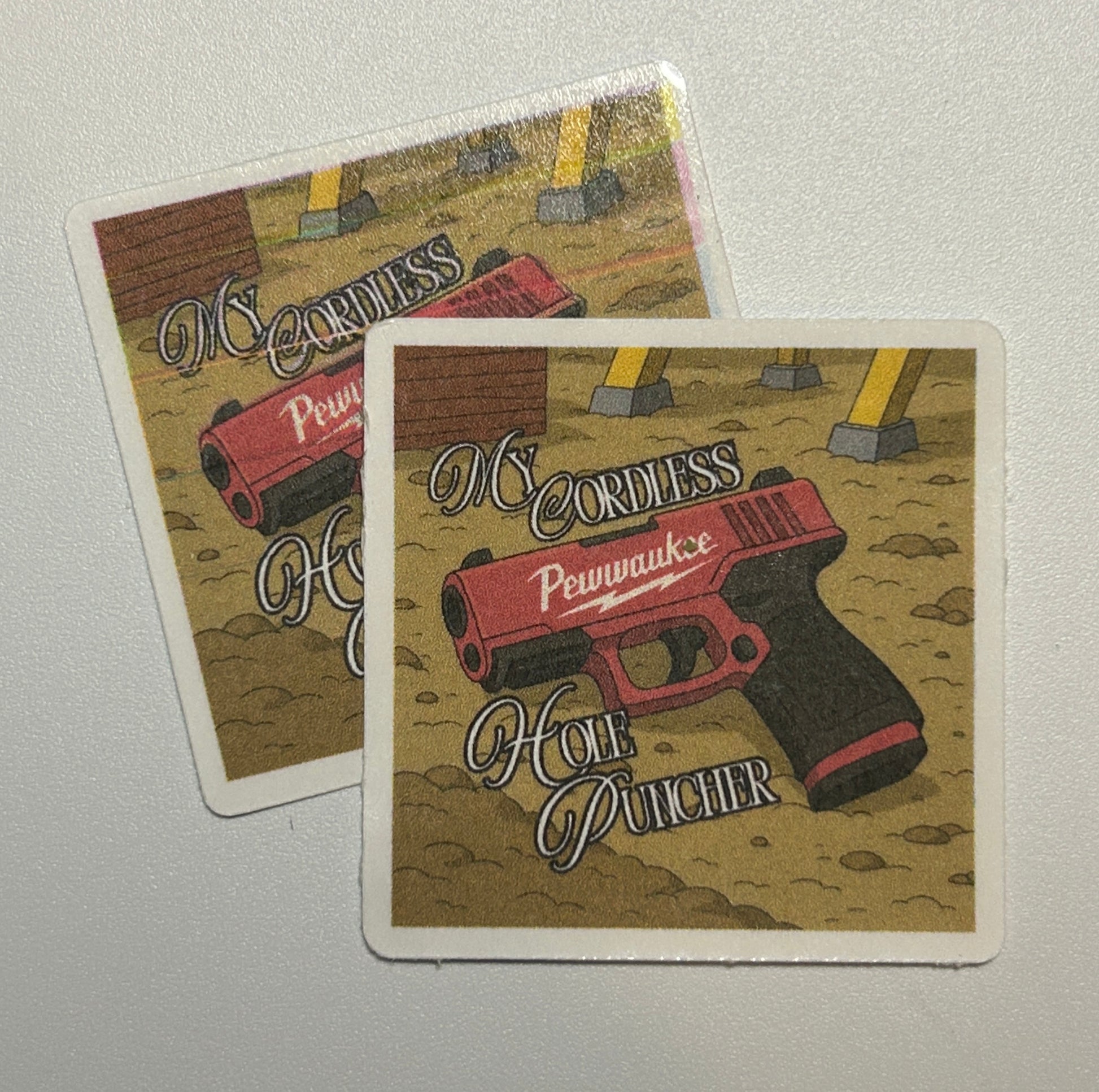 2 Square stickers displaying an illustrated cordless handheld tool on a textured background with decorative text.