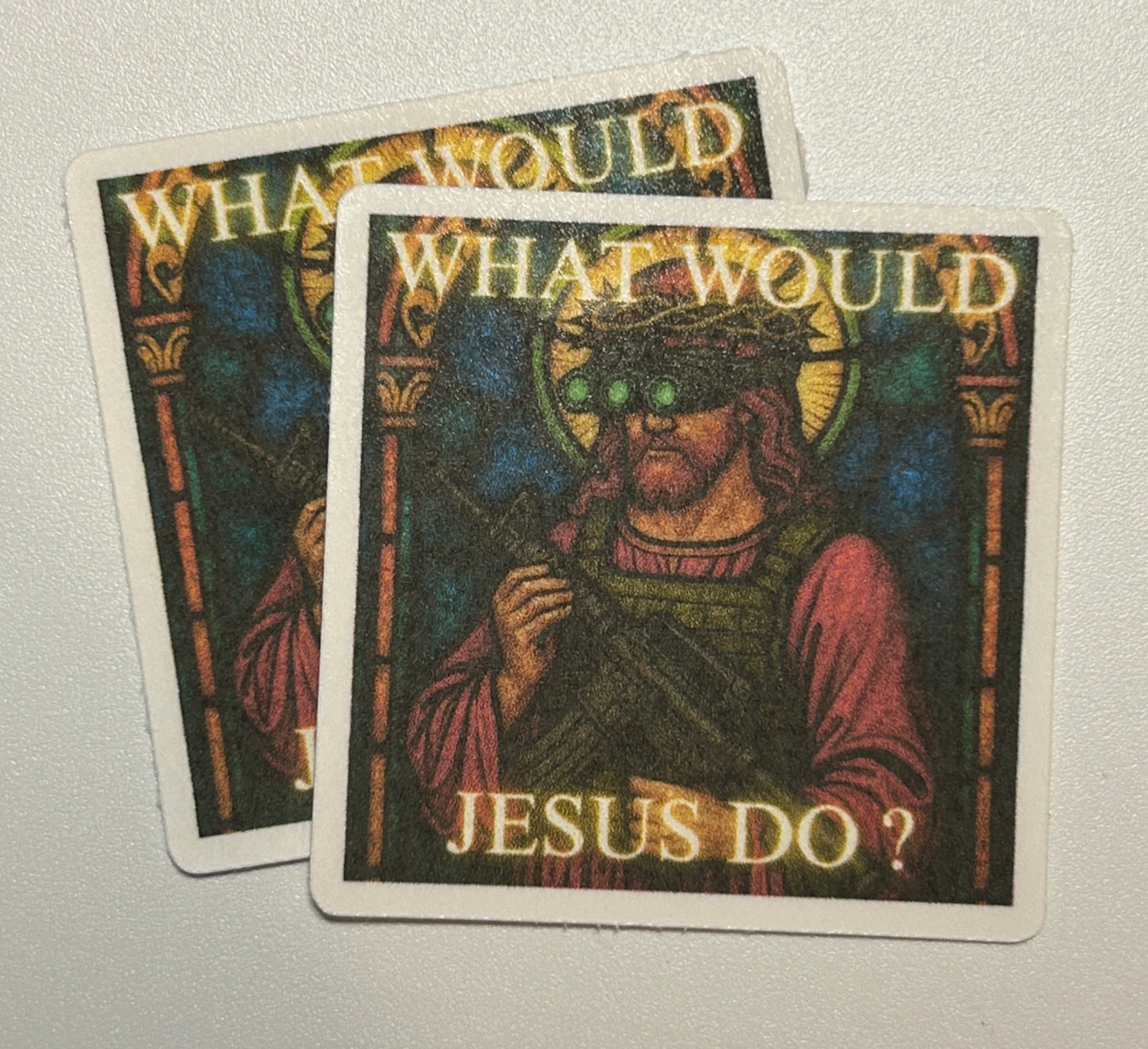 2 Square stickers featuring an illustrated human figure in a stained-glass art style with text elements on a dark, decorative background.