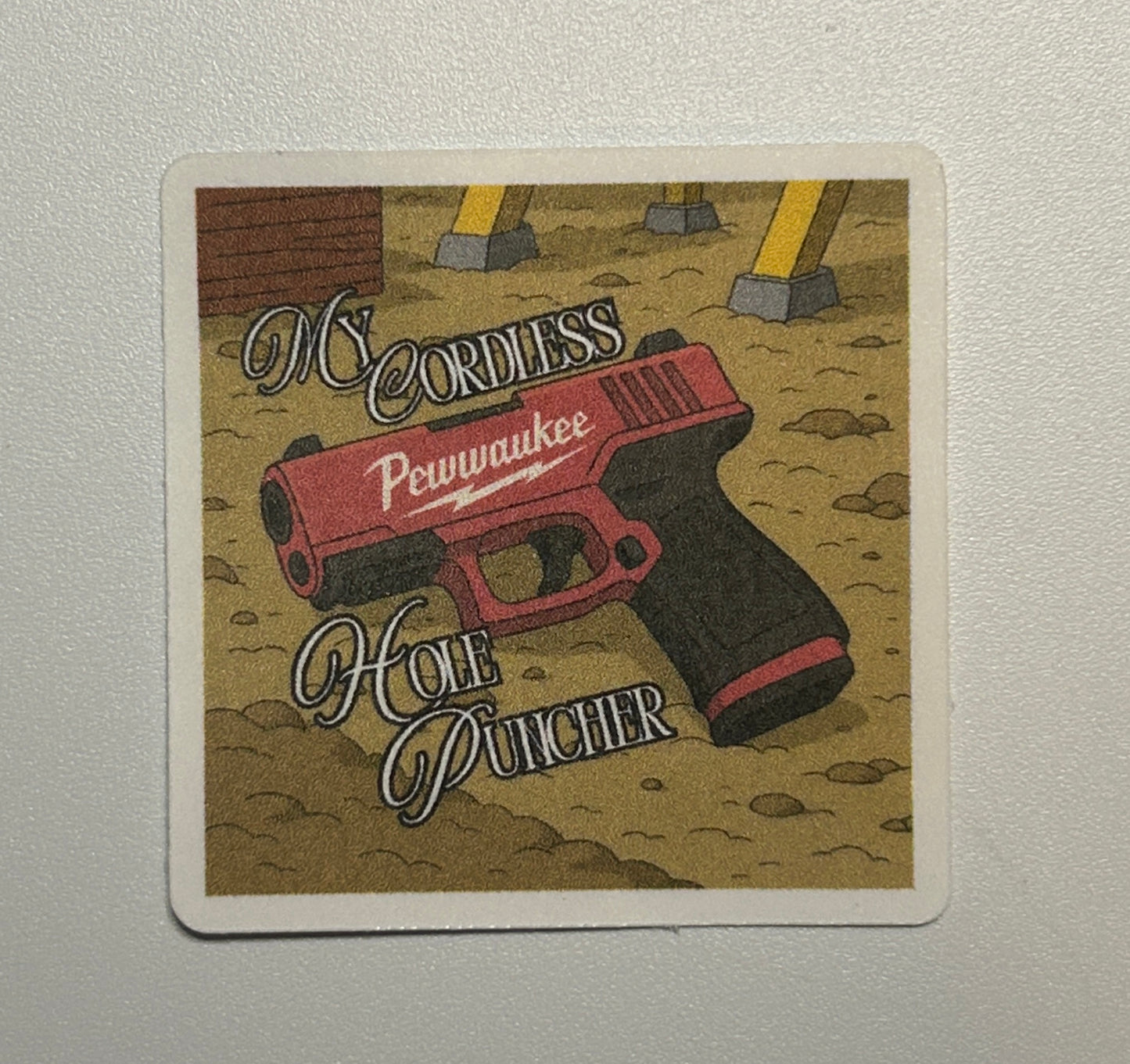 Square sticker displaying an illustrated cordless handheld tool on a textured background with decorative text.